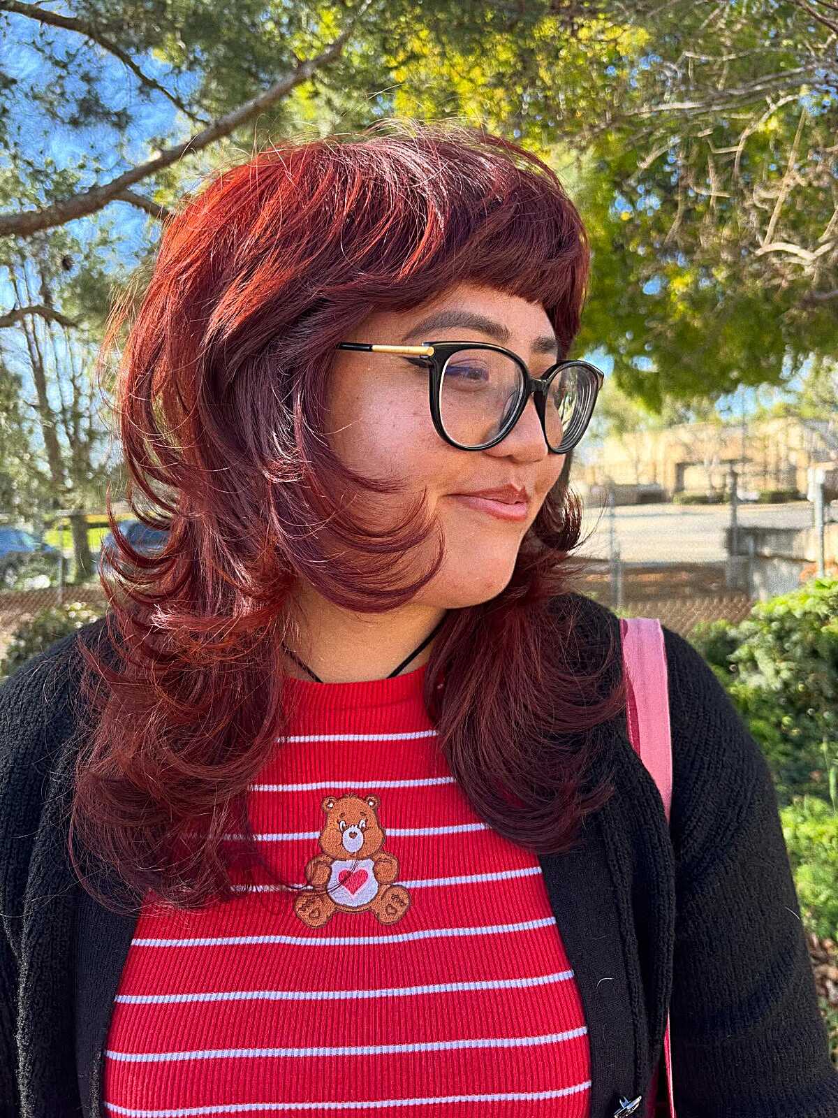 Layered burgundy and copper shag with bangs outdoors