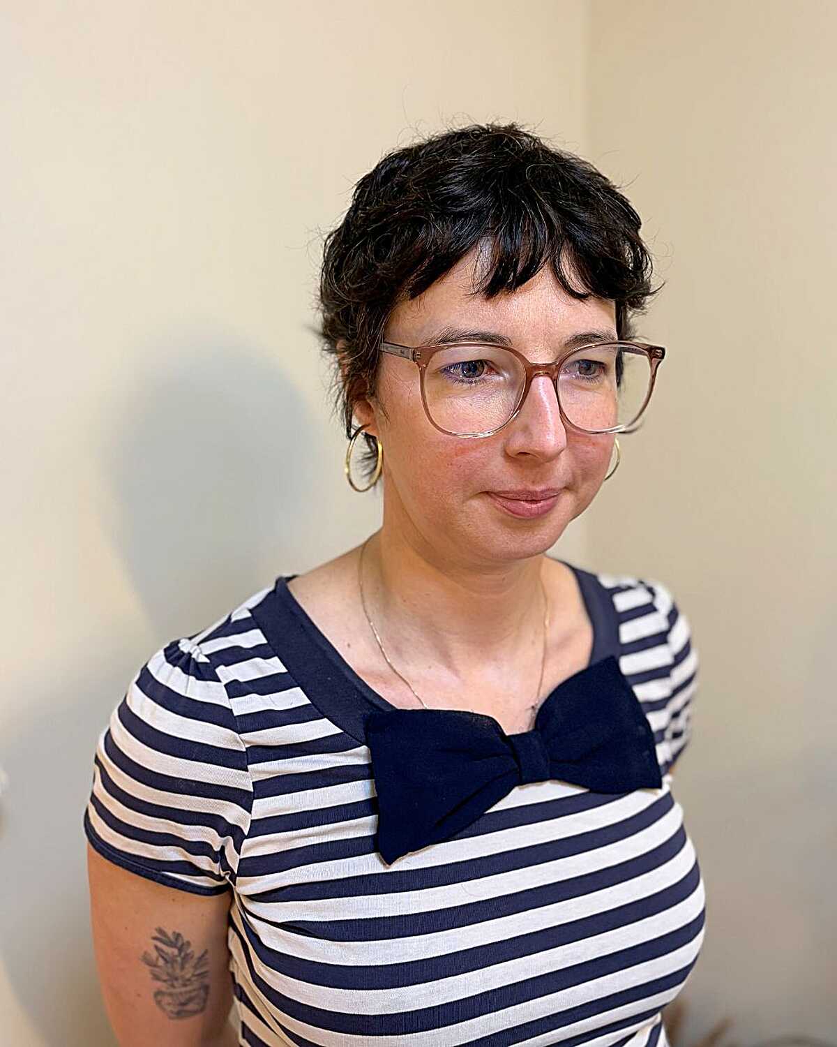 Very short curly dark brown pixie shag cut