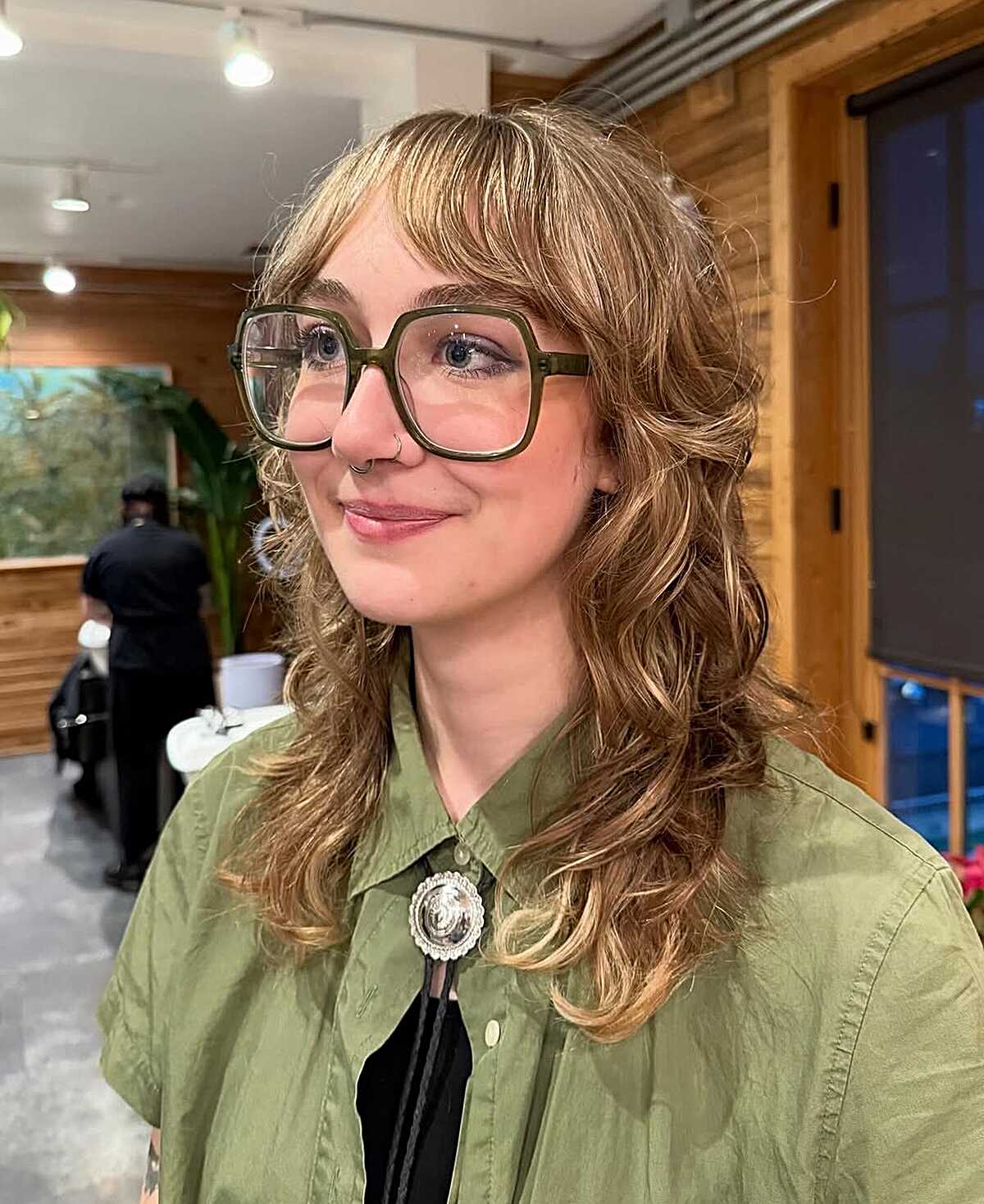 Golden blonde shoulder-length curly shag with bangs