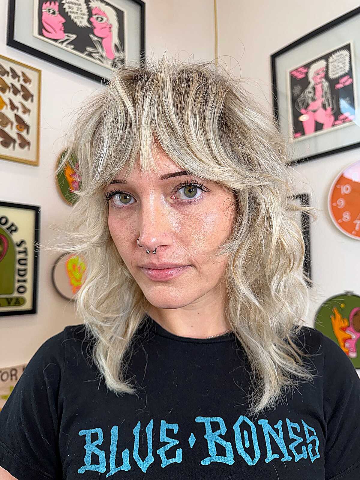 Shoulder-length icy blonde feathered shag with bangs