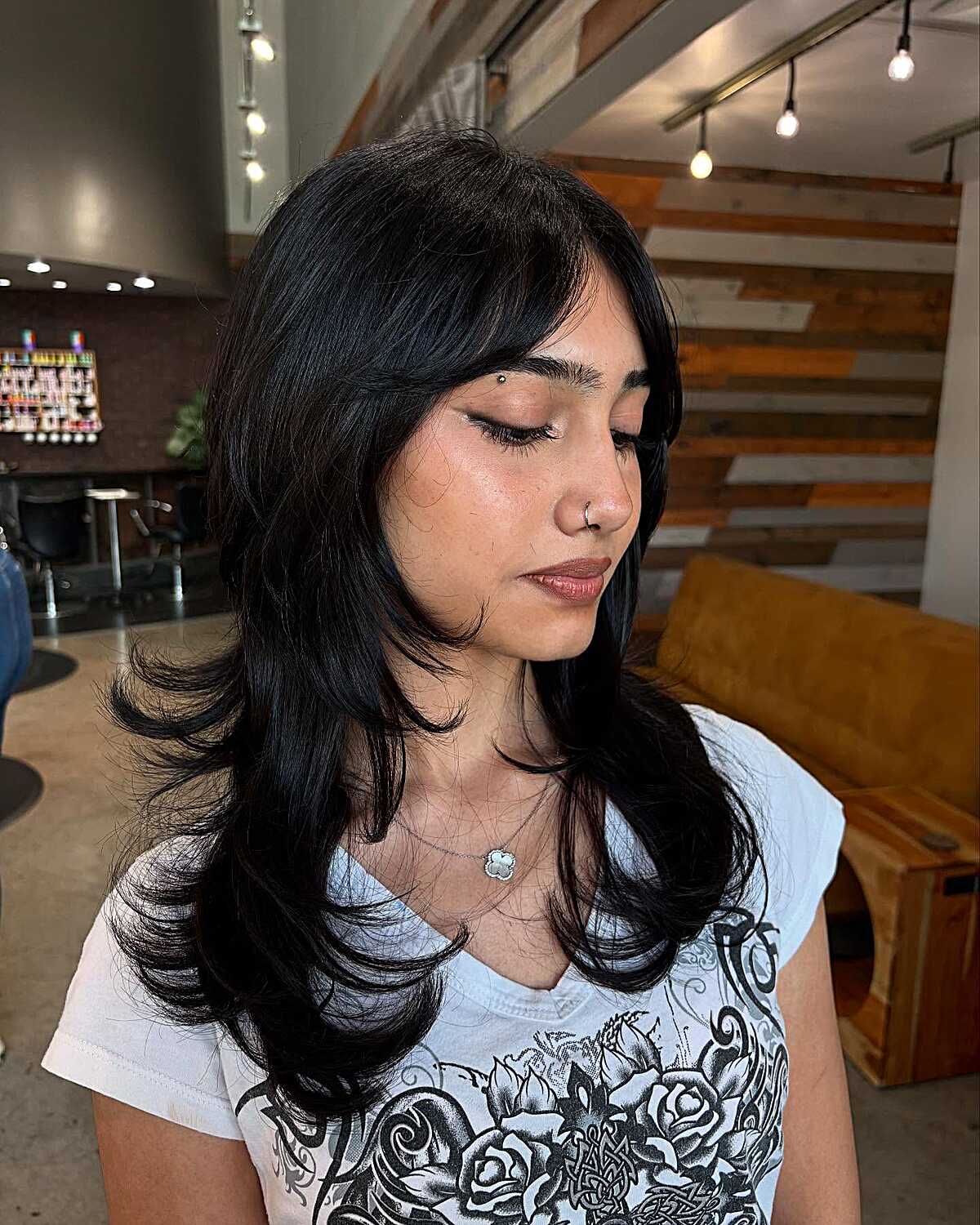 Long black shag with curtain bangs and flipped ends