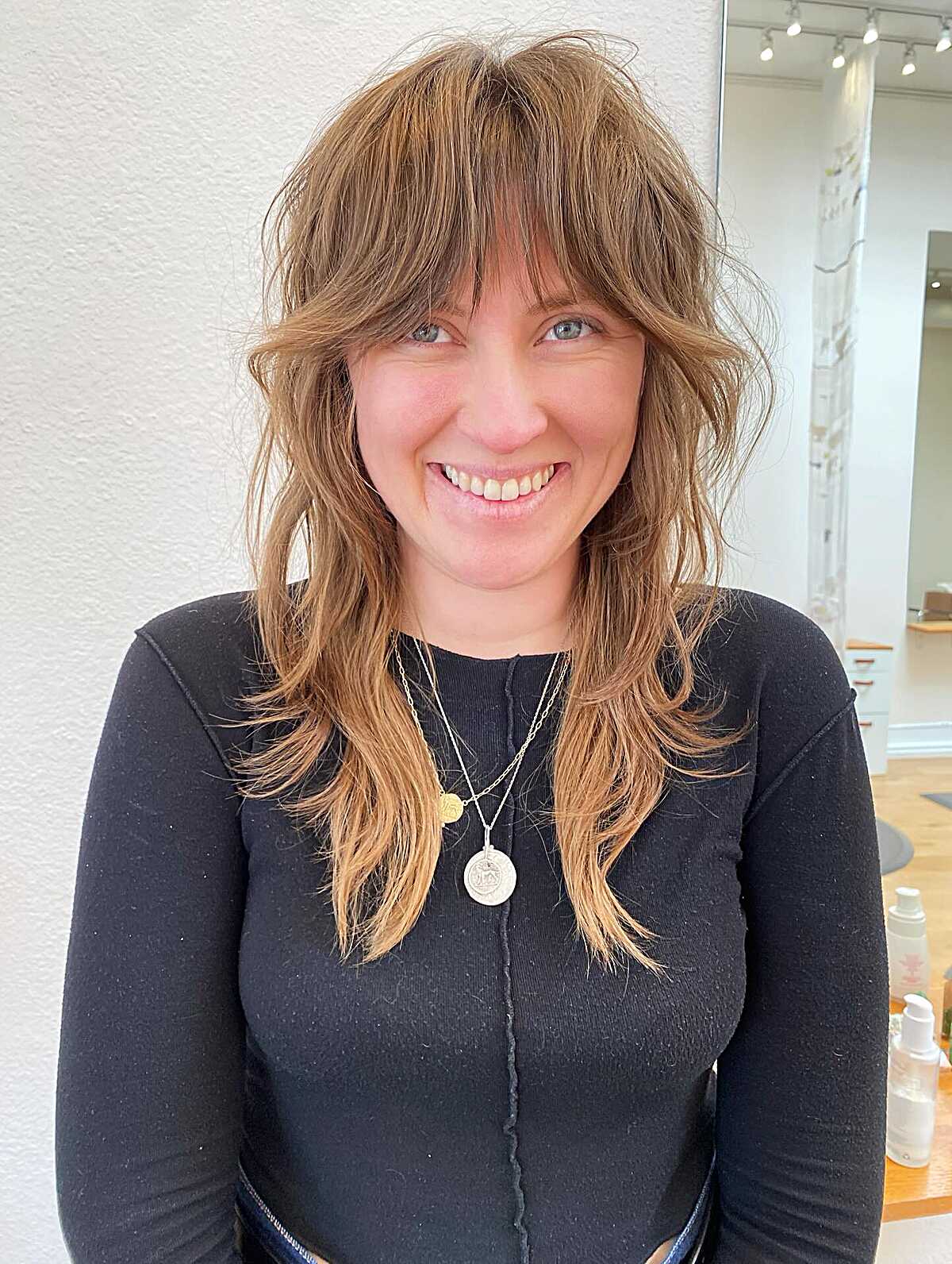 Wavy medium shag with honey highlights and bangs
