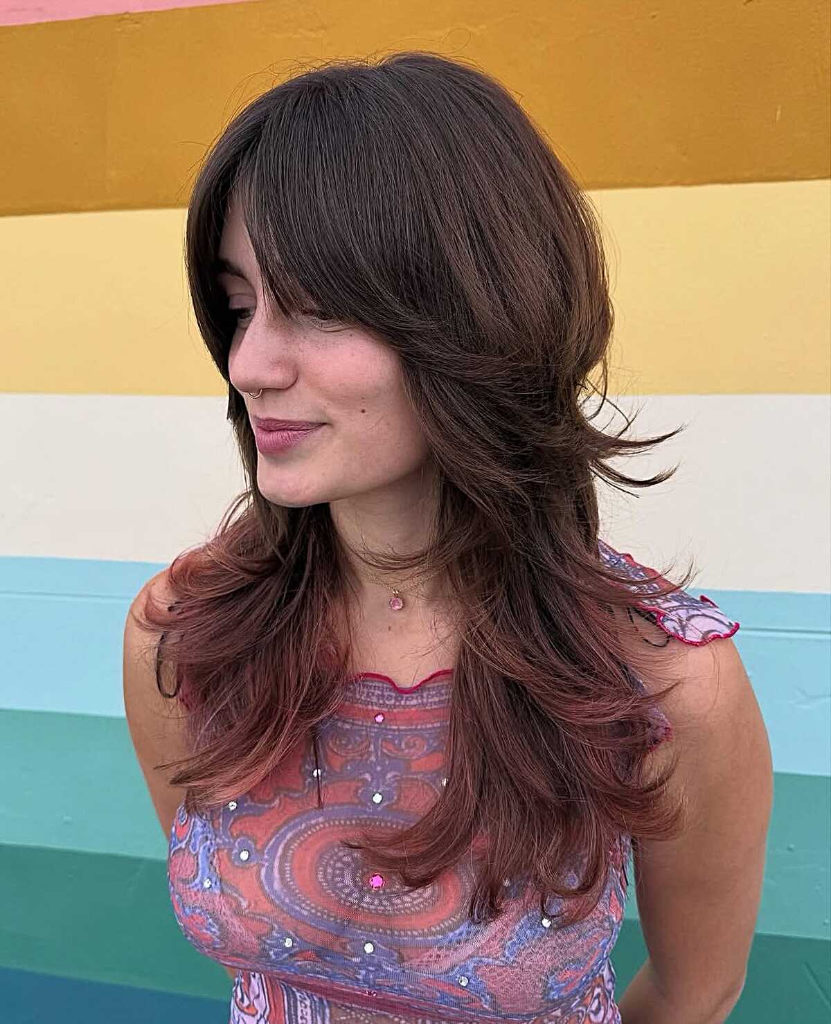 Long dark brown feathered shag with side-swept bangs