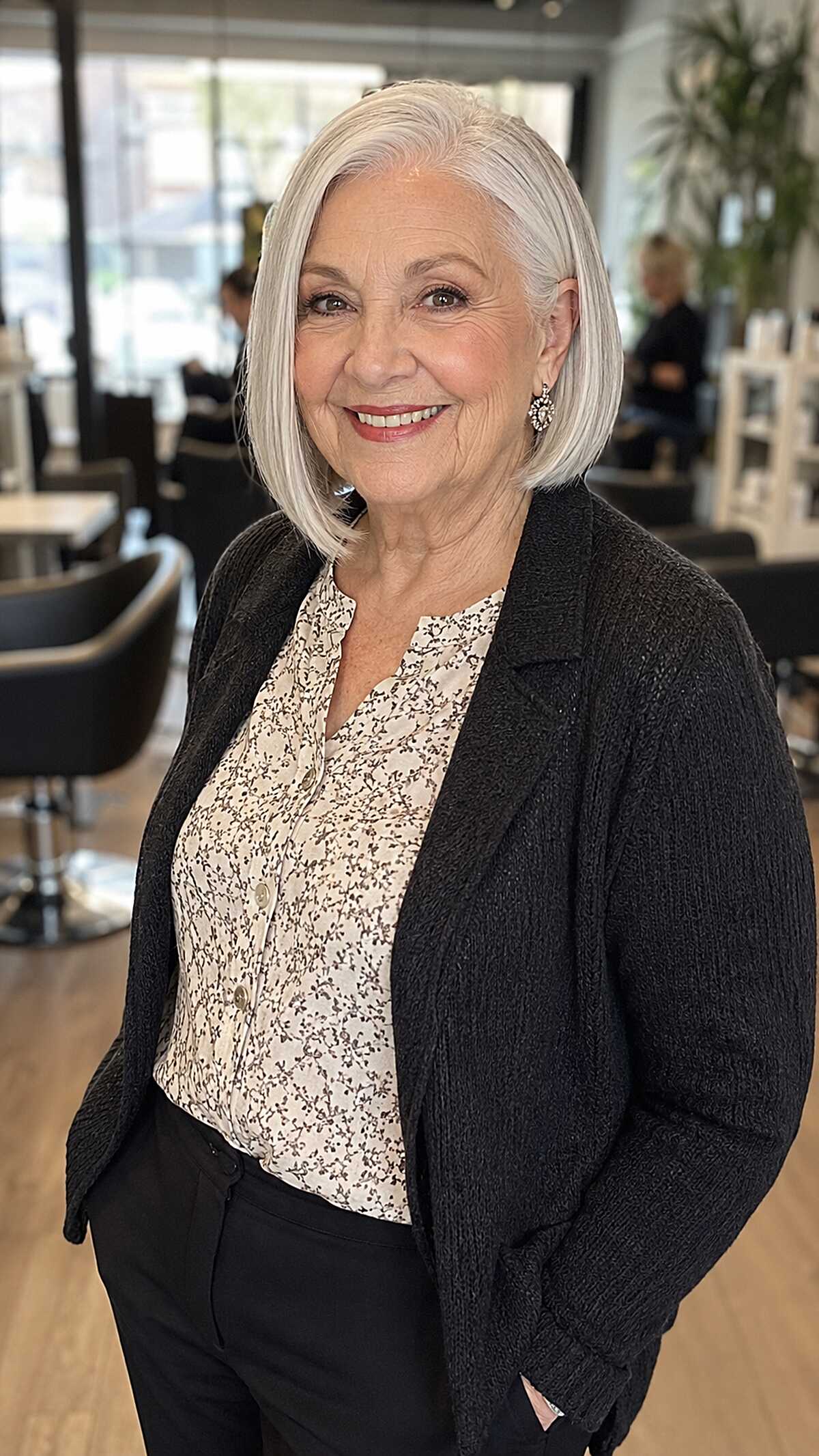 Silver side-parted bob with tucked ends on white hair