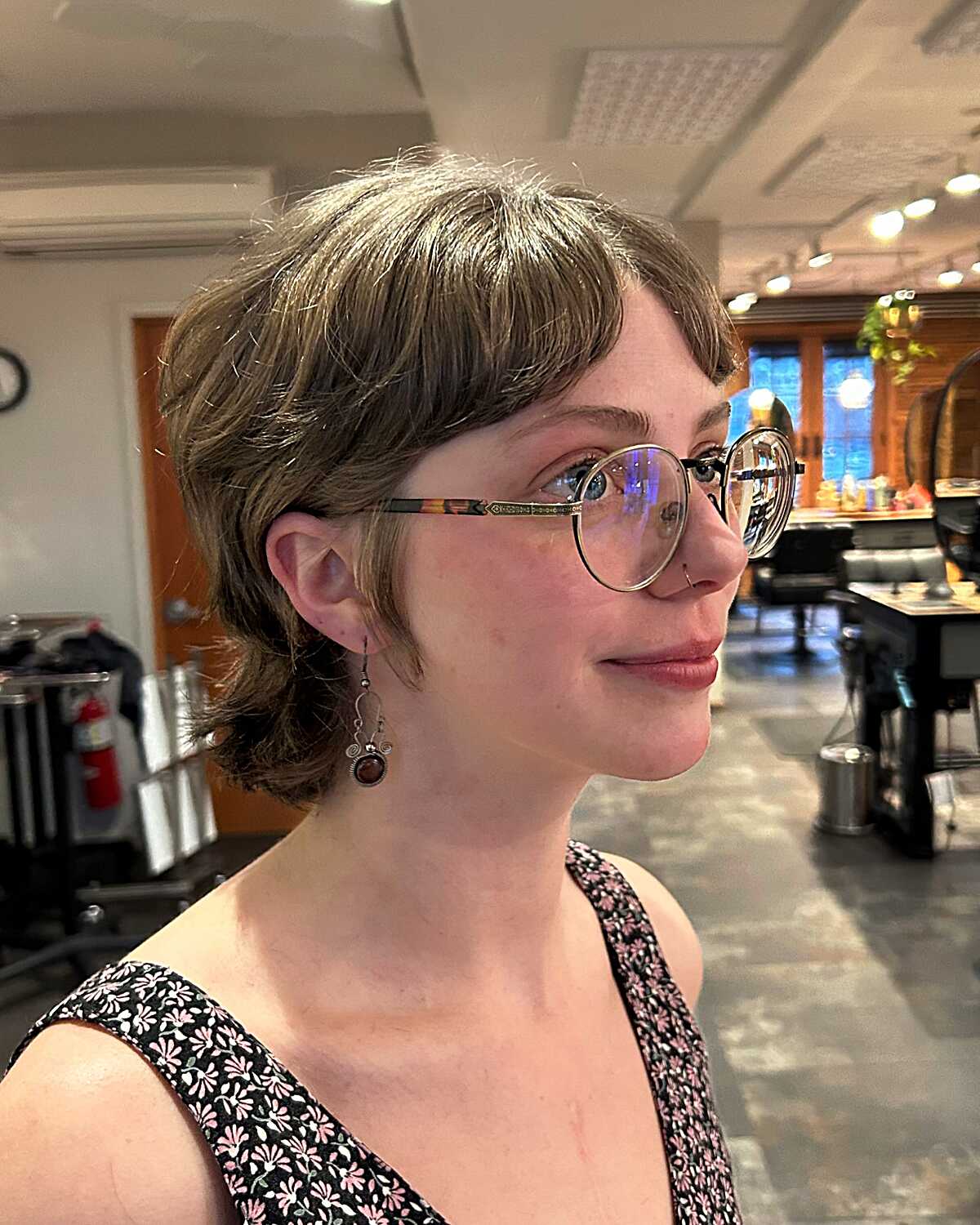 Short ash blonde feathered pixie shag with glasses