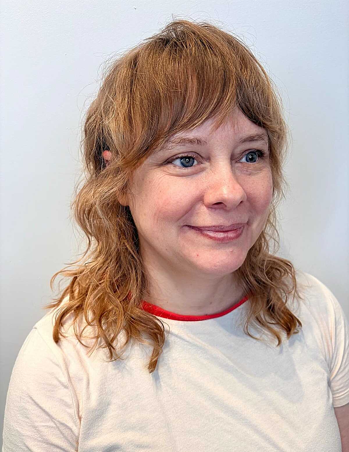 Strawberry blonde wavy shag with wispy layers