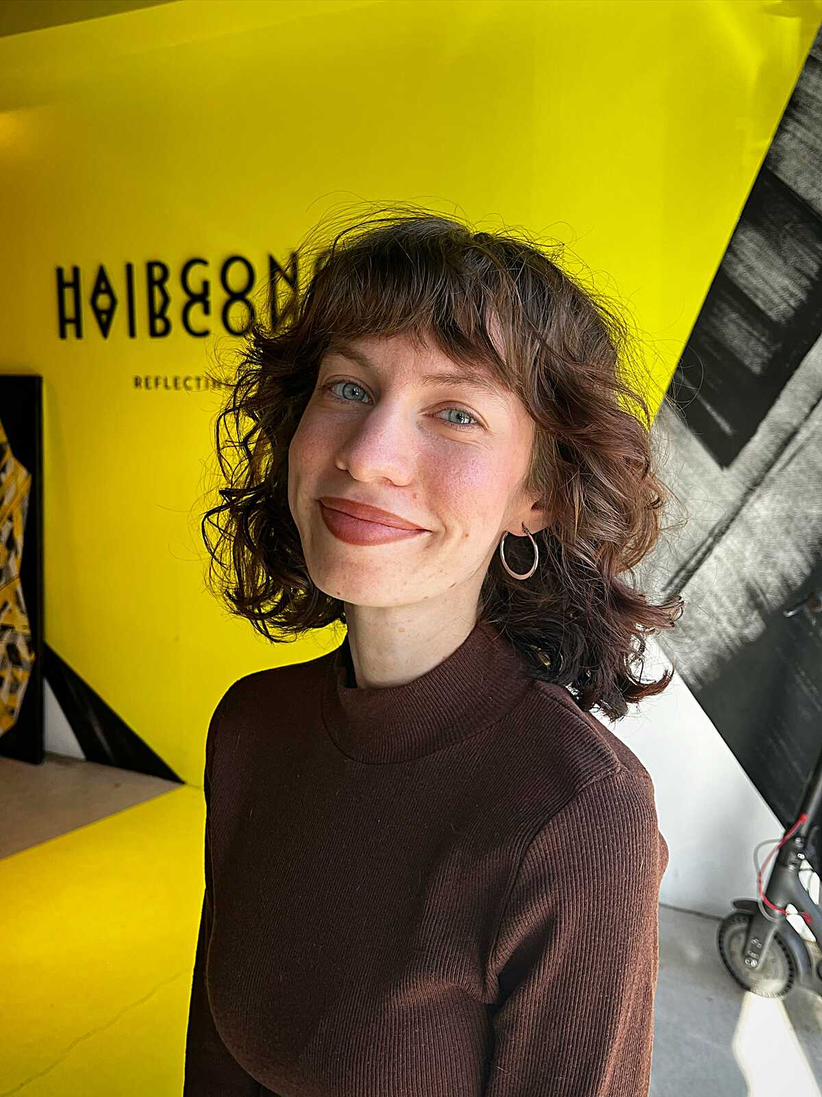 Tousled curly brunette bob shag with short bangs