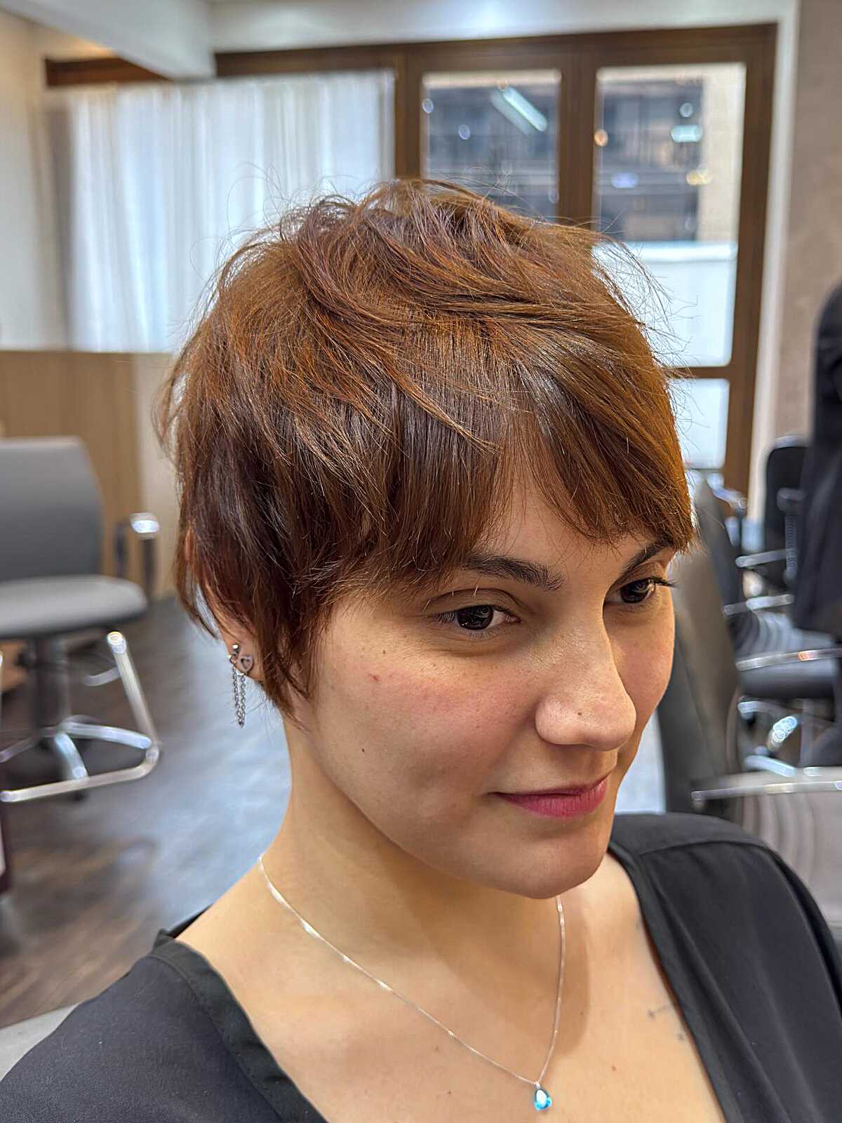 Warm Auburn Pixie Shag with Swept Layered Fringe and Textured Nape