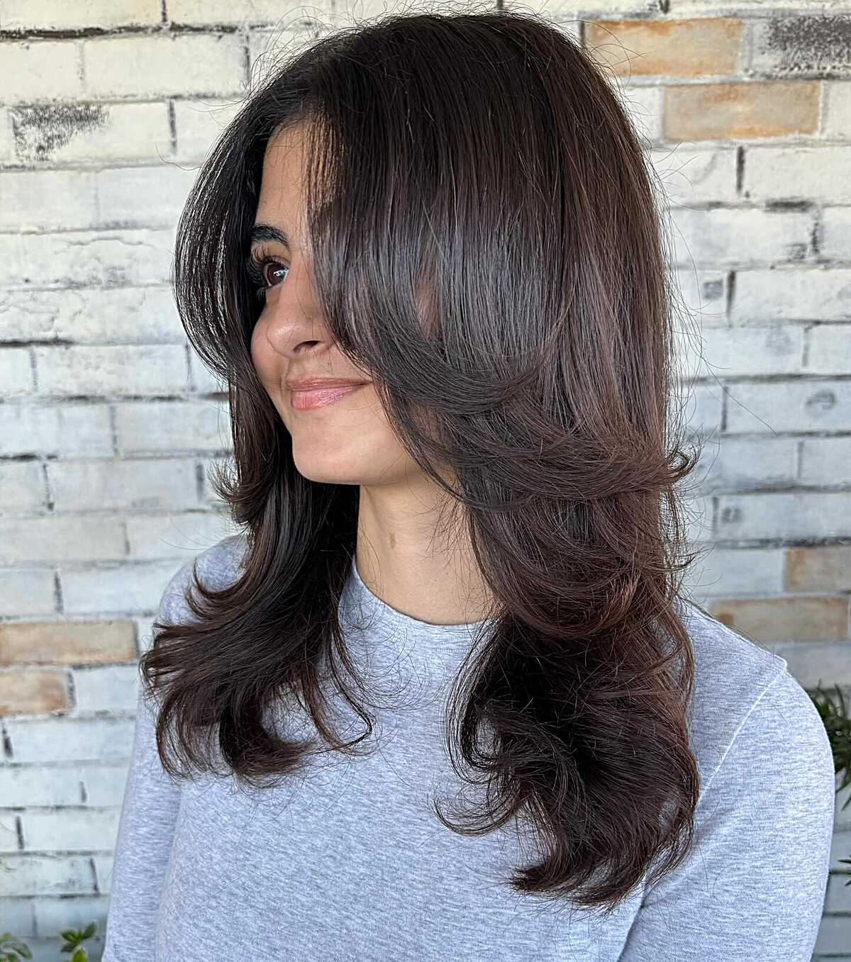 Dark Brunette With Cascading Layers and Curved Ends That Need a Round Brush