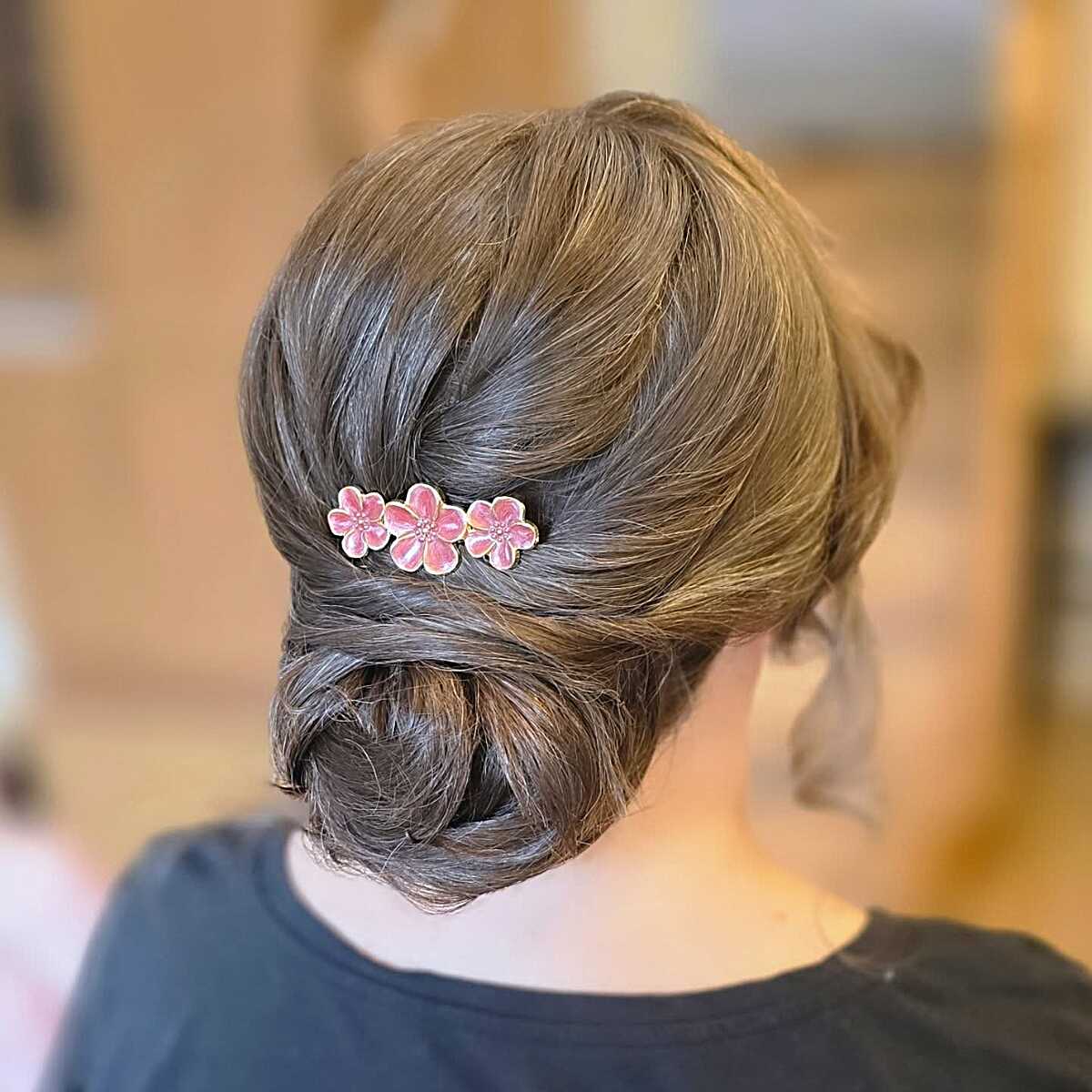 Loosely Gathered Low Bun with Pink Floral Pin on Natural Ash Brunette