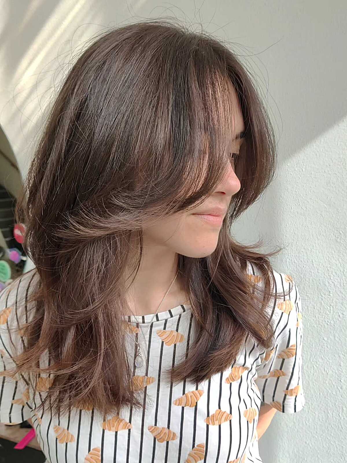 Medium Brunette With Wispy Interior Layers and Face-Framing Pieces