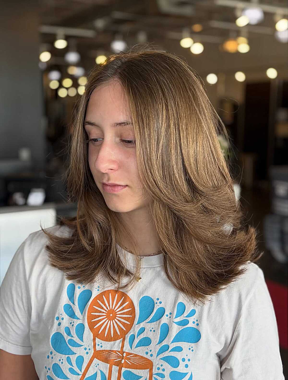 Medium Caramel Brunette With Rounded Layers and a Center Part That Pulls Its Weight