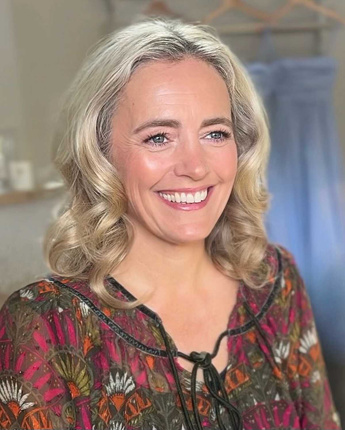 Shoulder-Length Silver Blonde Curls with a Center Part
