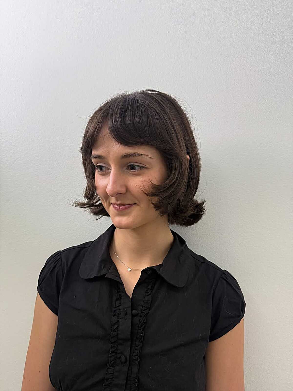 Brunette Chin-Length Bob With Baby Bangs and Retro Flipped Ends