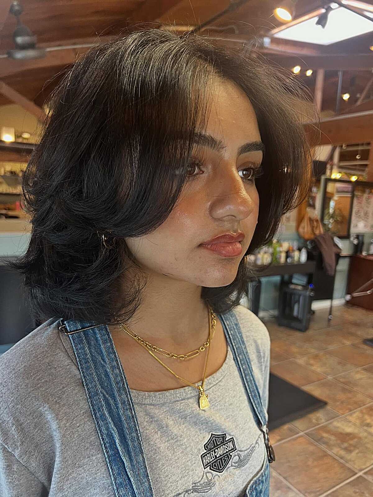 Dark Layered Bob With Swooped Side Part and Curled-Under Ends