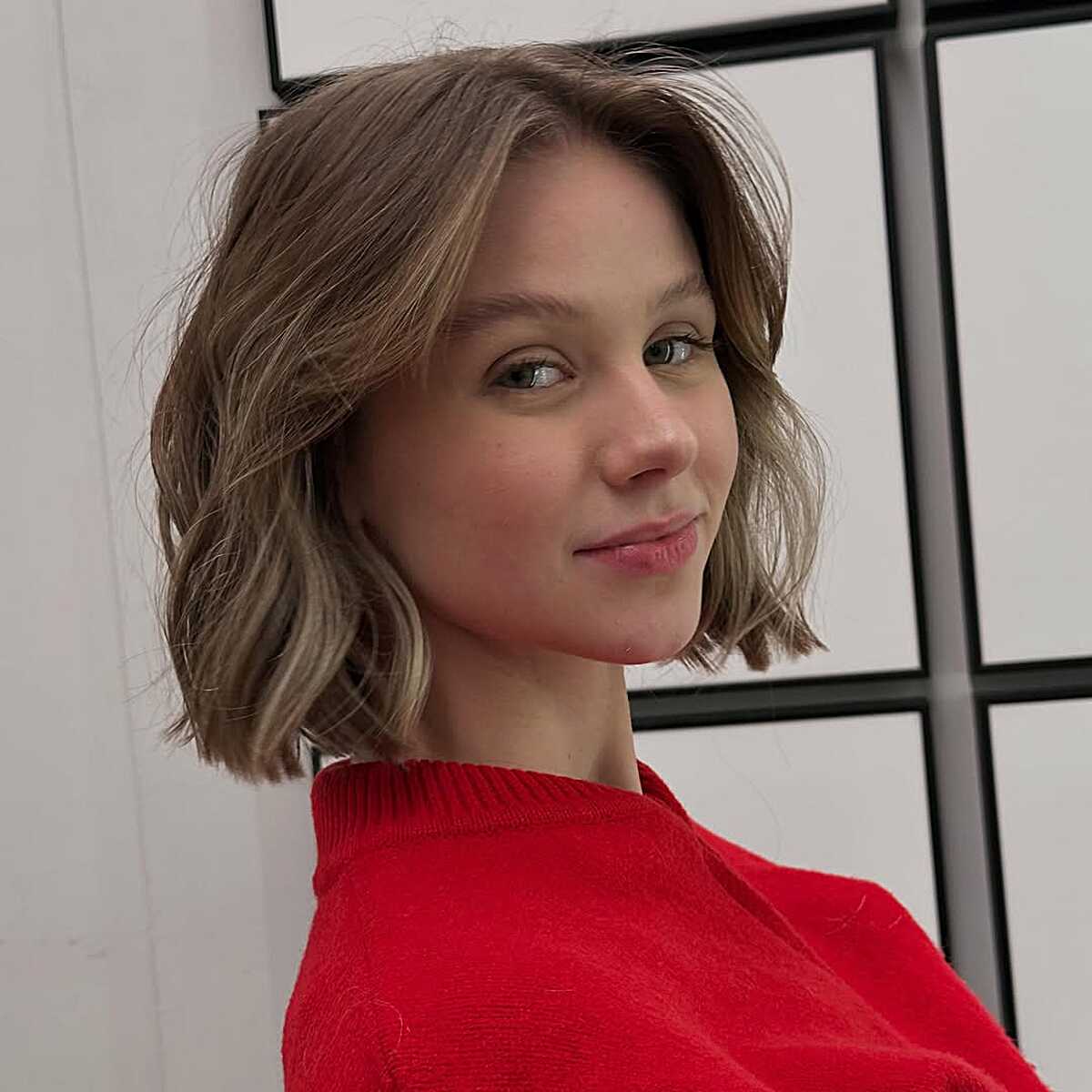 Wavy Chin-Length Bob With Soft Bronde Balayage and a Low Side Part
